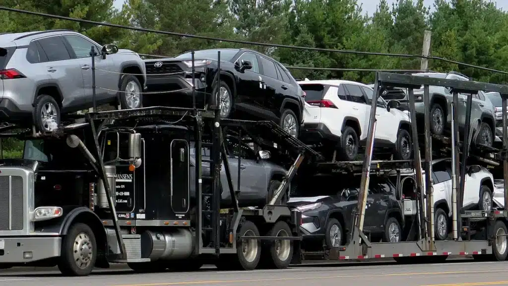Loaded car hauler transporting multiple vehicles on a highway