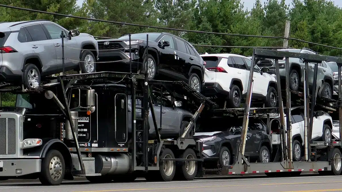 Loaded car hauler transporting multiple vehicles on a highway