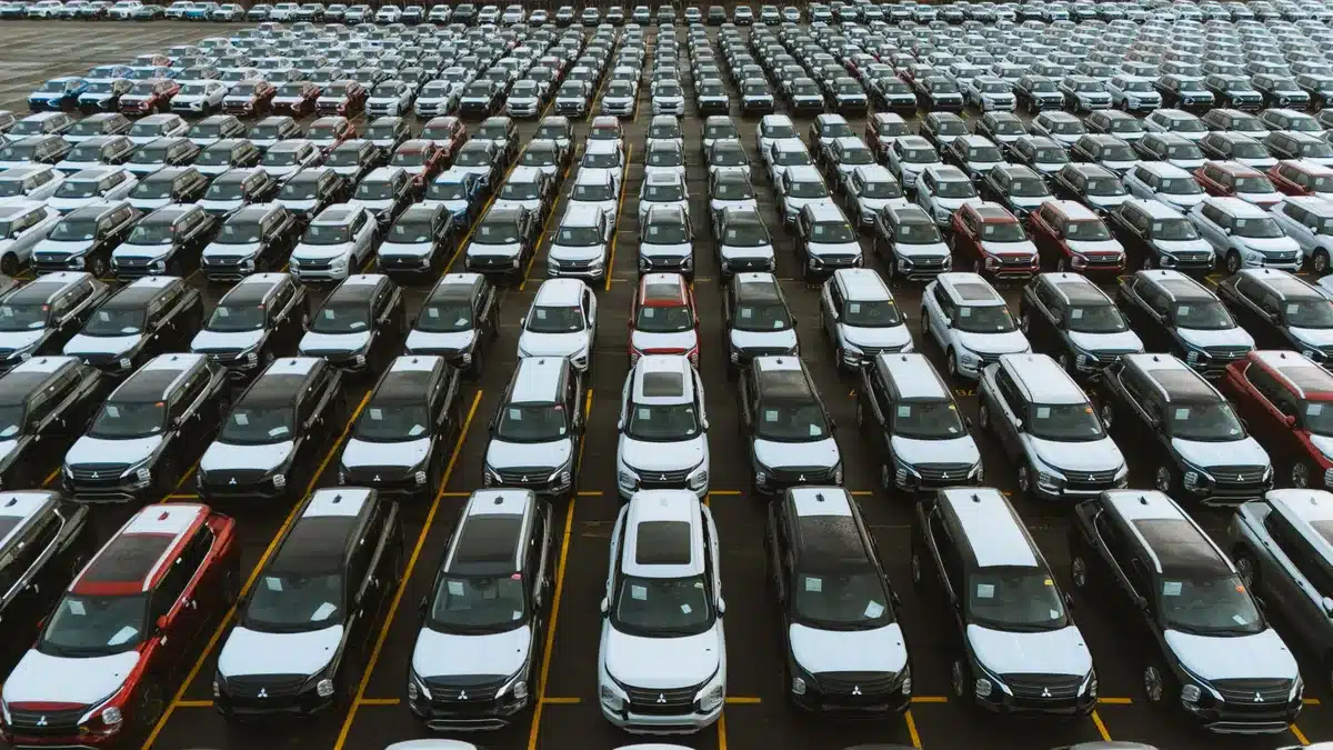 Aerial view of rows of new vehicle inventory at a dealership lot
