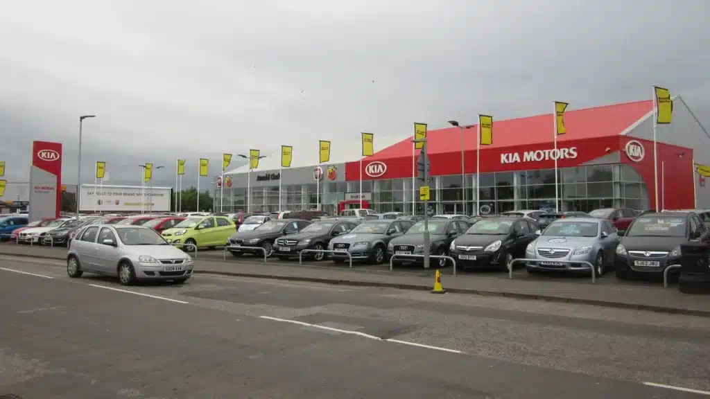 New car dealership lot with rows of inventory vehicles