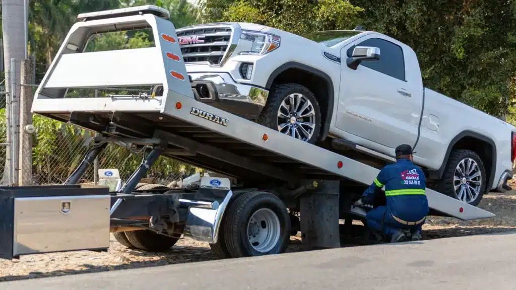 Non-running pickup truck loaded onto a flatbed tow truck