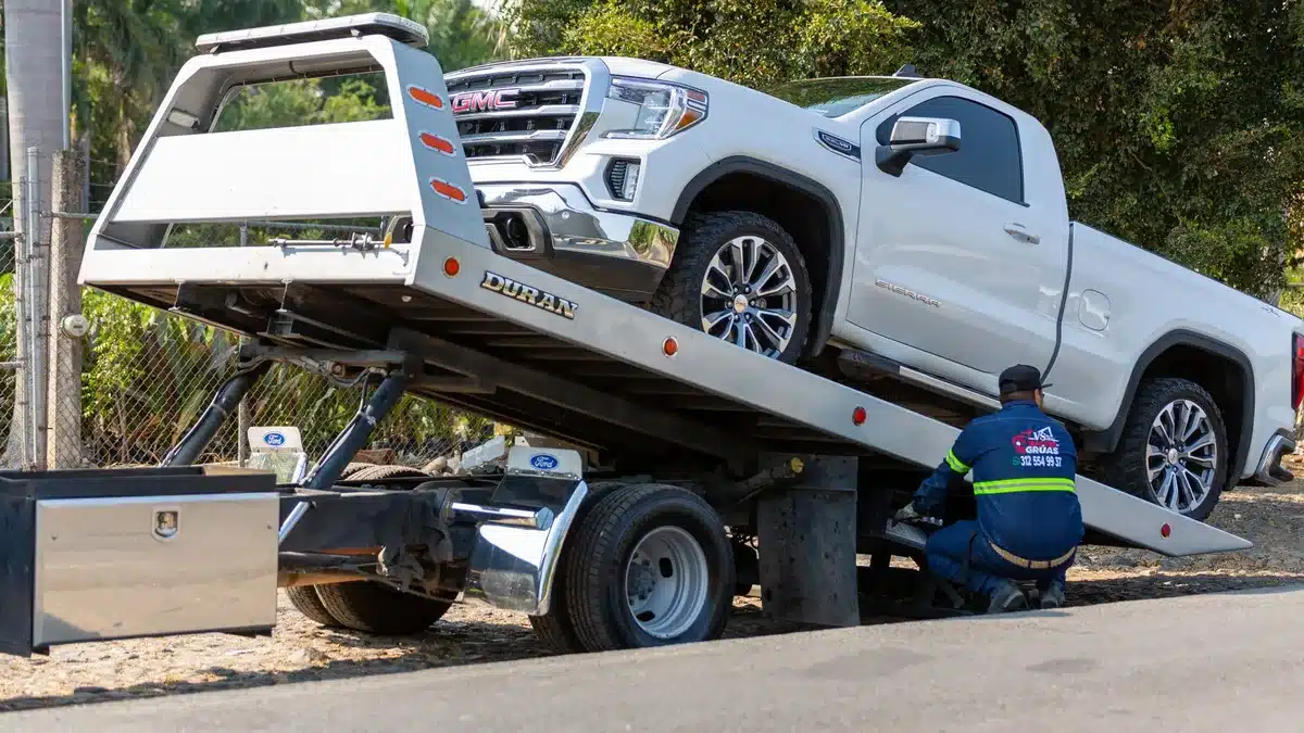 Non-running pickup truck loaded onto a flatbed tow truck