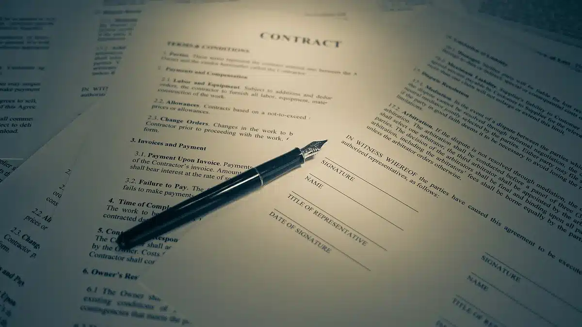 Auto transport contract with a pen resting on the signature page